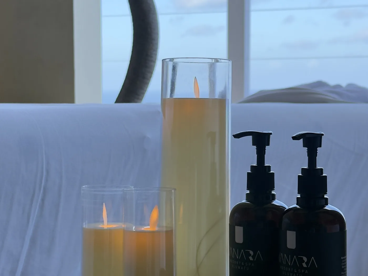 VANARA spa oils and candles prepared beside an ocean-view massage setting in Uluwatu