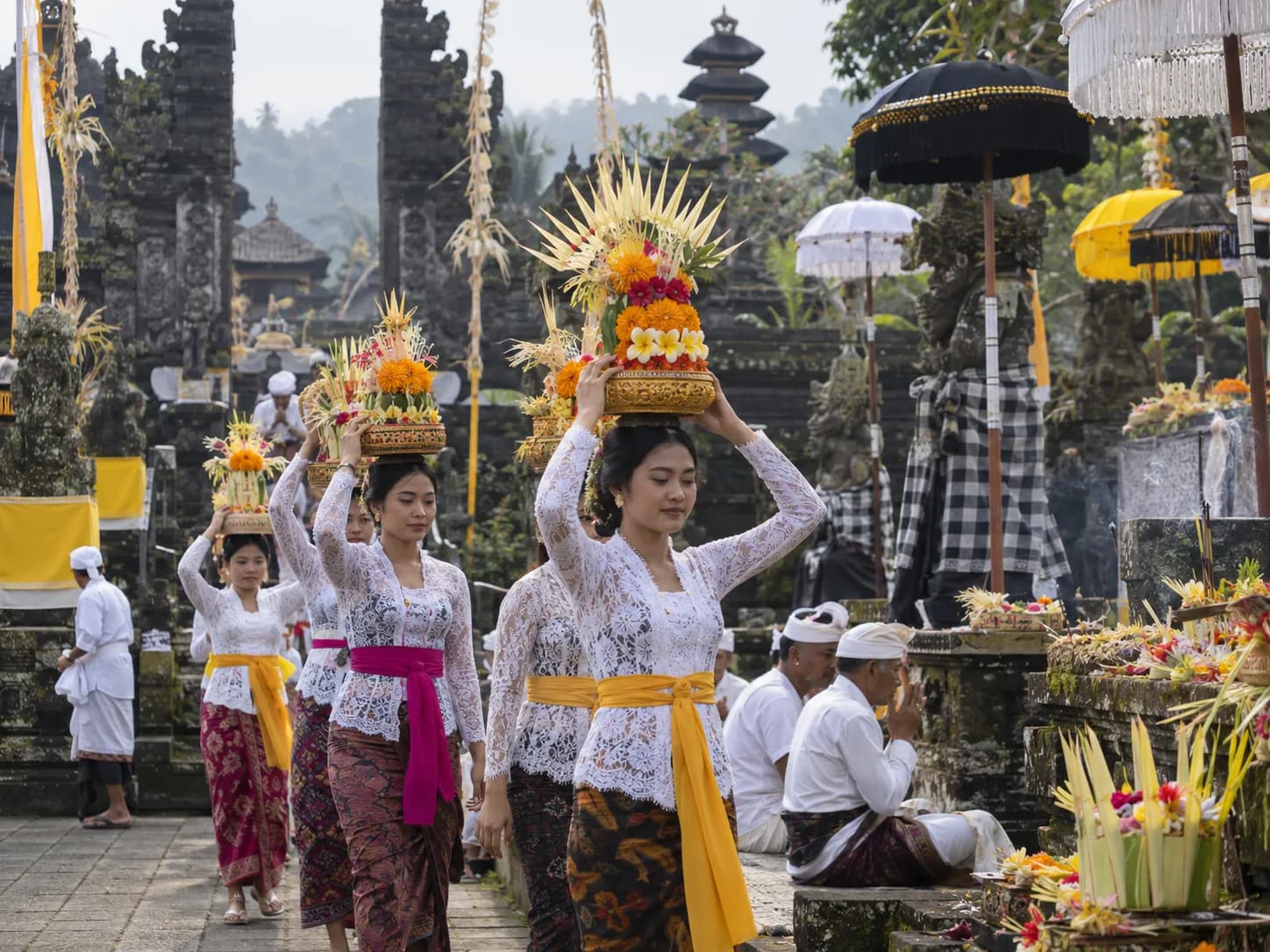 Balinese Hindu ceremony with traditional flower offerings at a temple